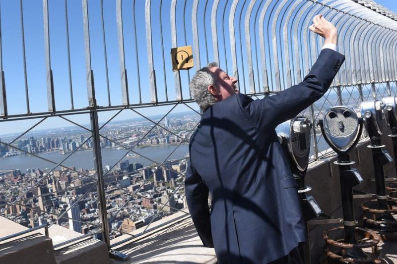 Fotografía cedida por la oficina del alcalde de la ciudad de Nueva York donde se ve al alcalde Bill de Blasio tomándose una foto en la terraza del Empire State este sábado, en Nueva York (EE.UU.).
